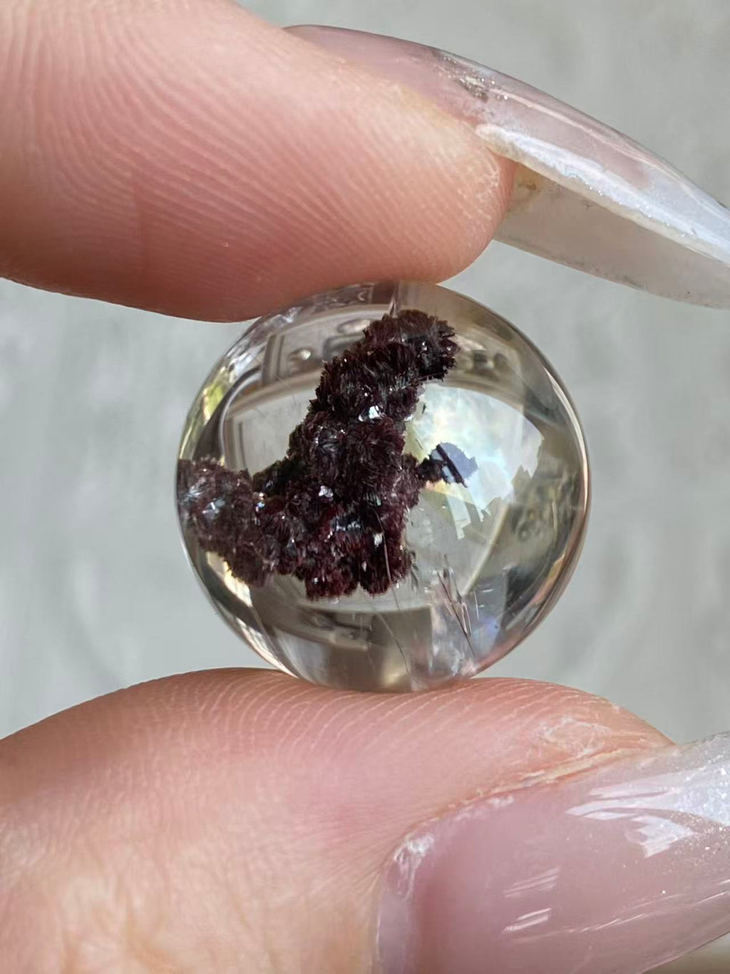 Sealed Godzilla crystal sphere held in hand showing size