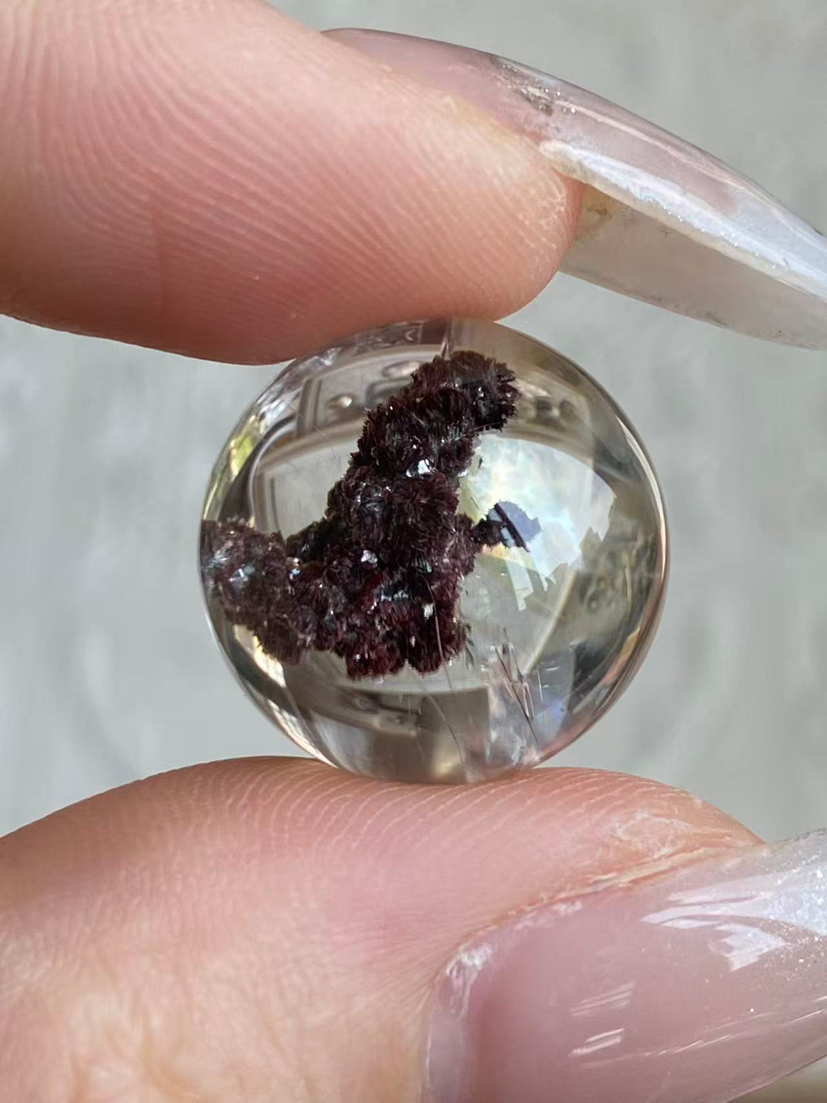 Sealed Godzilla crystal sphere held in hand showing size